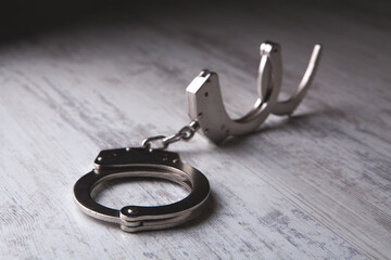 closeup of handcuffs on obscure stainless steel