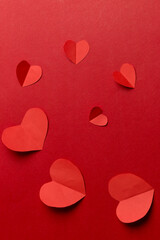 Use scissors to cut into heart-shaped pieces of paper