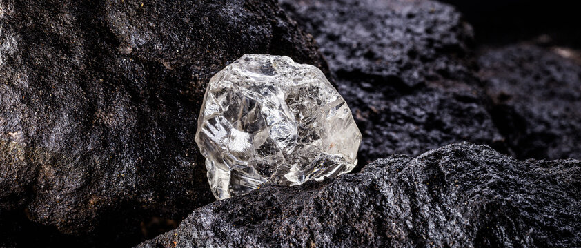 Rough diamond, precious stone in mines. Concept of mining and extraction of rare ores.