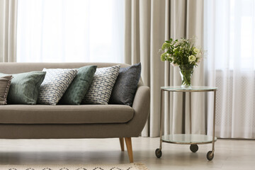 Sofa with pillows in modern living room interior