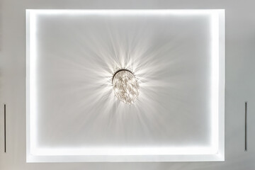 looking up on suspended ceiling with halogen spots lamps and drywall construction in empty room in...