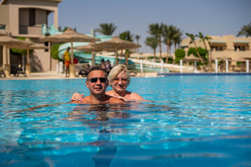 Fototapeta premium Happy family, married couple or friends relaxing and have fun in swimming pool