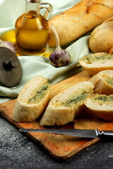 Vintage kitchen board with delicious homemade garlic bread on table