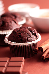 Three chocolate brownies with cinnamon and coffee cups