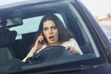Fototapeta na wymiar Young pretty scared woman in the car