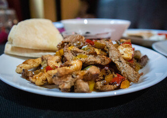 Mexican fajitas with a side of tortillas and black beans