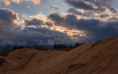 volumetric clouds on a background of sandy desert at sunset