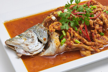 Crispy fried fish topped with delicious dipping sauce, a popular dish.