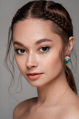Beautiful woman face. Perfect makeup. Beauty. Cosmetic. Eyeshadow. Elegant hairstyle. Jewelry