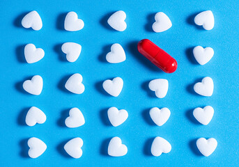 heart-shaped tablets and red pill. pattern medicine, cardiology