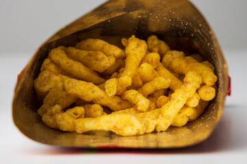 Crispy Fried Crunchy cheese snacks in bag package. Fast food or junk food snacks unhealthy concept.