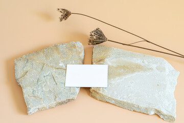 Business card branding mockup template with space for your logo or design. Natural stones and dry...