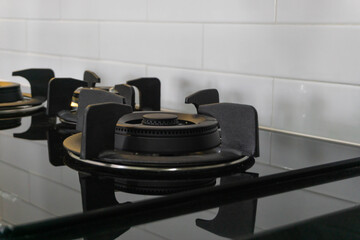 Burner black gas hob of a white modern kitchen.