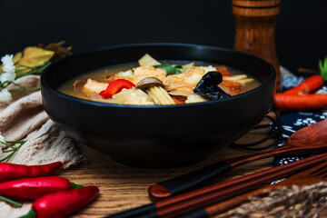 Bowls of Asian soup noodles and vegetables with Chopstick
