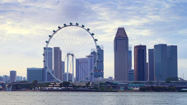SINGAPORE - FEBRUARY 2: Time lapse video 4K, Beautiful moment of Singapore Ferris Wheel and business and financial district, Modern building in the city center on February 2, 2020 in Singapore.