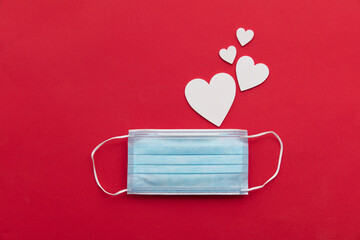 Valentine's day covid-19 background with surgical mask and white love hearts