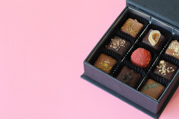 box of premium Belgium chocolate candies on pink background