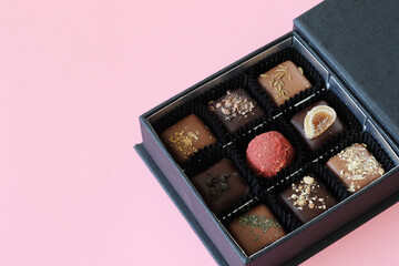 box of premium Belgium chocolate candies on pink background
