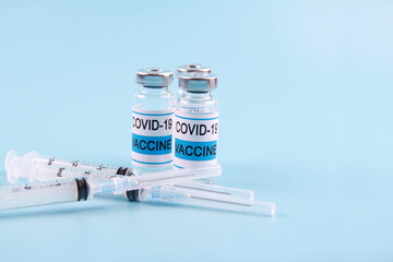 The Nobel coronavirus vaccine covid-19 is a bottle with an illustrative picture and a syringe for injection. The concept of prevention,immunization, vaccination and treatment of coronavirus infection.
