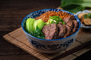 Taiwanese famous food beef noodle on wooden table.