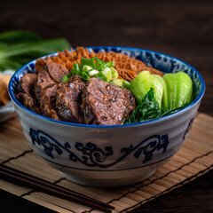 Taiwanese famous food beef noodle on wooden table.