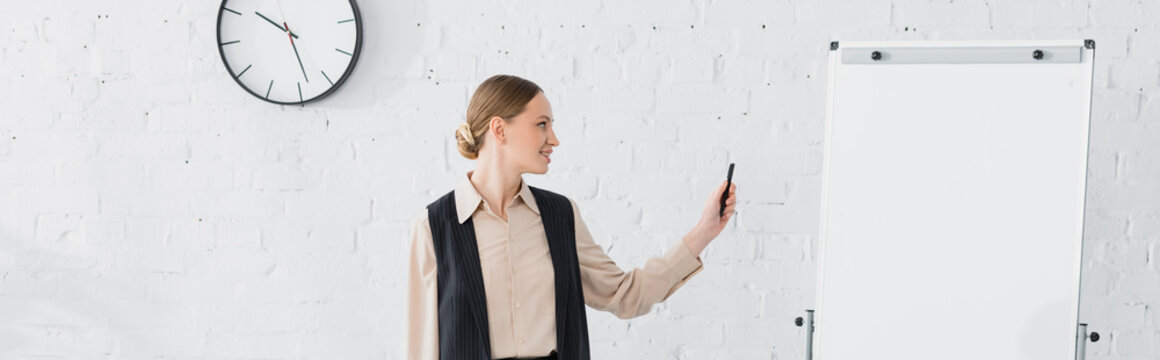 Cheerful Speaker Looking At Blank Flipchart During Seminar, Banner