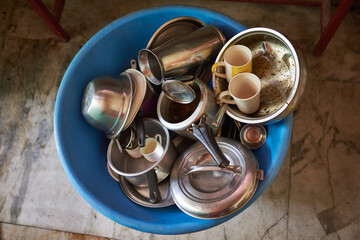 steel and silver utensils lying in the washing bowl