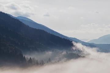 Beautiful mountain landscape. Sky with clouds and fog on the hills