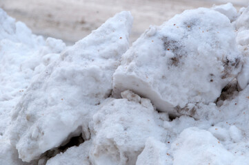 Winter. Large pieces of snow removed from the road after a heavy snowfall.