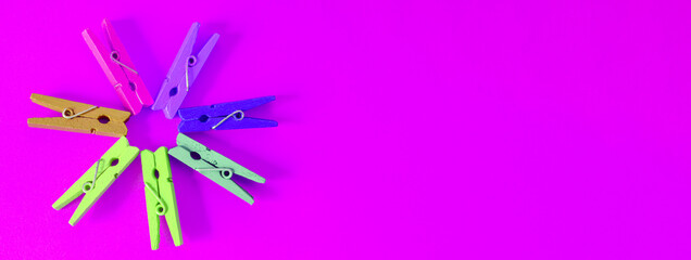 Banner concept of mood-boosting color, multi-colored wooden multi-colored clothespins in the shape...