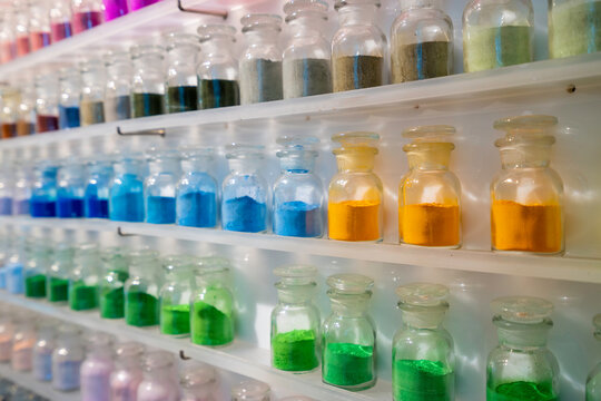 Row of colorful dry powder in glass bottle