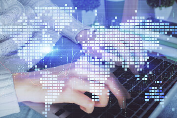 Double exposure of woman hands typing on computer and business theme hologram drawing. Success concept.