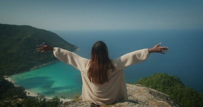 Traveler Woman on vacation raised hands on mountain peak viewpoint Enjoying freedom celebrating moment of life