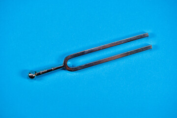 Tuning fork on blue background.