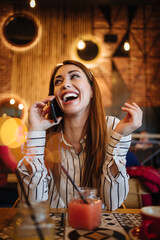 Beautiful young adult woman sitting in a nice restaurant or coffee bar and enjoying in fresh good coffee drink.