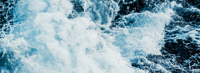 Natural texture of rough sea surface breaking against rocks