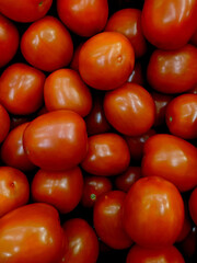 lot of tomatoes in the market closeup photo