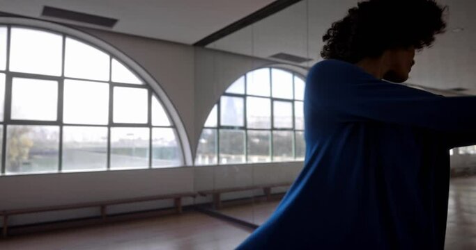 African-american woman spinning dancing ballet in dance studio