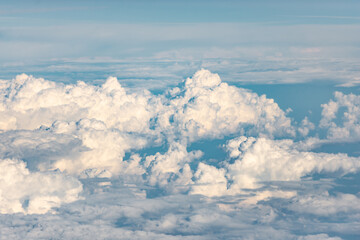 Clouds from the plane window. The world of aerial illusions at an altitude of 10 km