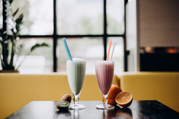 two glasses with milk shake. Strawberry and kiwi milk shake