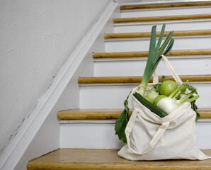Plastic free groceries shopping bad full of green vegetables and fruits from local organic market.