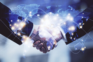 Double exposure of business theme hologram and handshake of two men. Success concept.