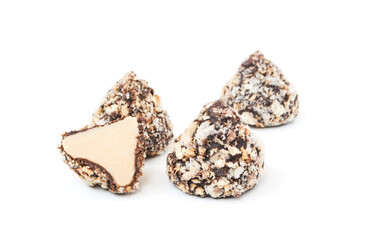 Chocolates with sprinkles in the form of pyramids isolated on white background