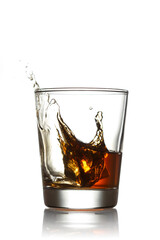 Glass of whiskey with splashes