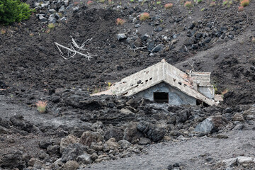 House buried under lava on southern flank of Mount Etna volcano, Sicily, Italy