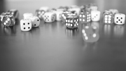 black and white dices game on wooden table top selected focus