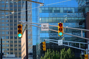 Traffic light in modern city and No turns sign on white.