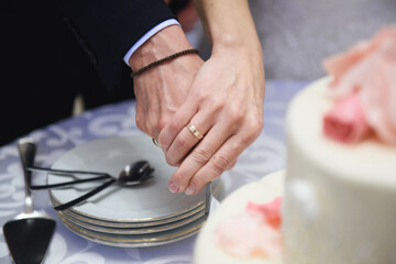 newlyweds hands cutting cake