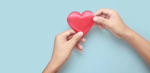 Fototapeta premium Hands holding red heart. heart health donation concepts