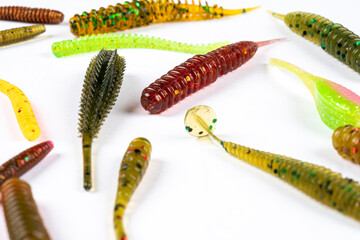 Fototapeta premium Jig silicone fishing lures isolated on a white background. Silicone fishing baits isolated. Colorful baits. Fishing spinning bait. Silicone soft plastic bait lure